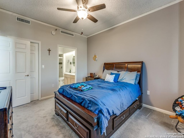 bedroom with ensuite bathroom, ceiling fan, ornamental molding, a textured ceiling, and light colored carpet