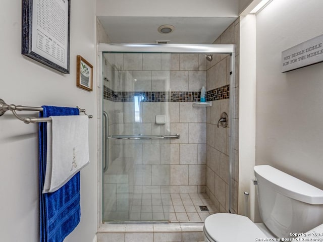 bathroom featuring toilet and walk in shower