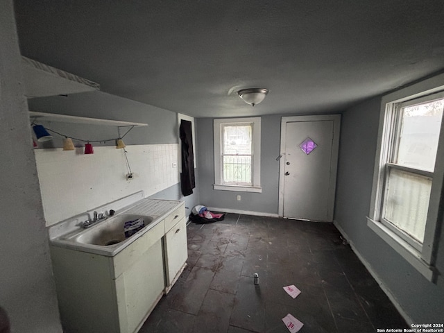 kitchen featuring sink and white cabinets