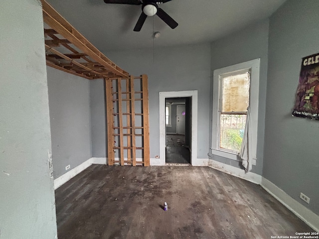 unfurnished room with dark hardwood / wood-style flooring and ceiling fan