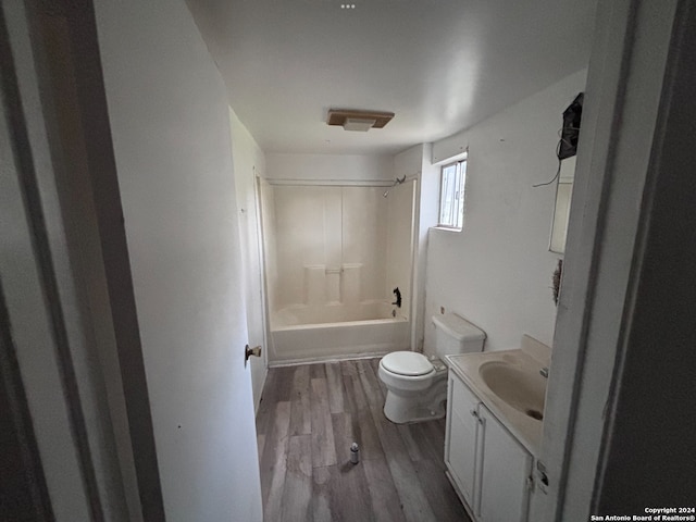 full bathroom featuring hardwood / wood-style flooring, vanity, toilet, and shower / bath combination