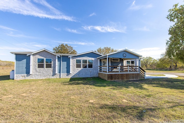 back of property with a yard and a porch