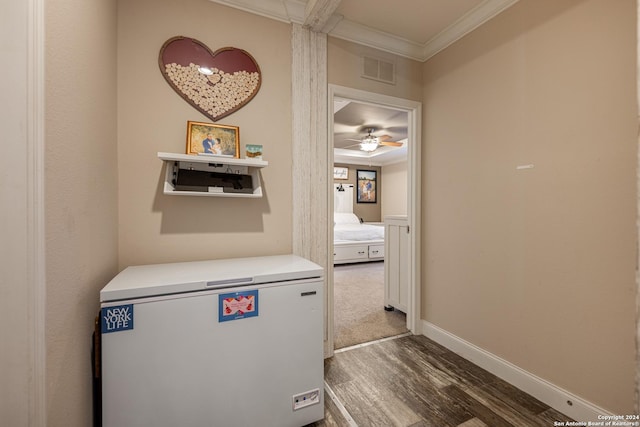 corridor featuring crown molding and hardwood / wood-style flooring