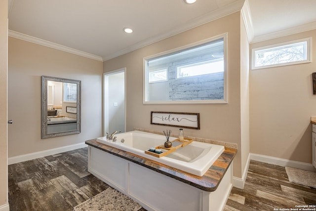 bathroom with a bath, crown molding, a healthy amount of sunlight, and wood-type flooring