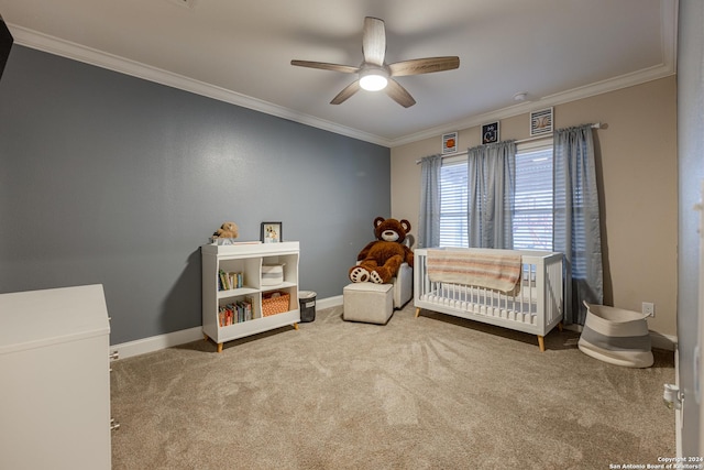 carpeted bedroom with ceiling fan, crown molding, and a nursery area