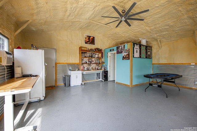 interior space featuring a workshop area, ceiling fan, and lofted ceiling