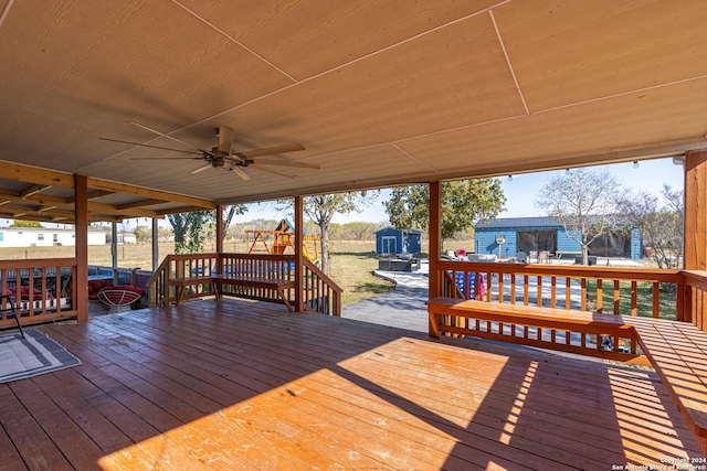 wooden terrace with ceiling fan and a shed