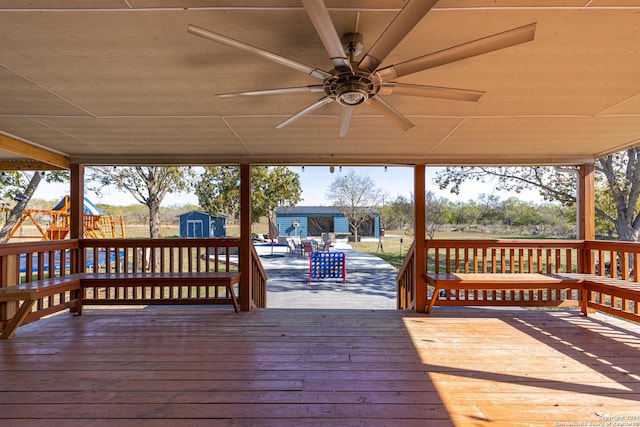 wooden terrace with ceiling fan and a storage unit