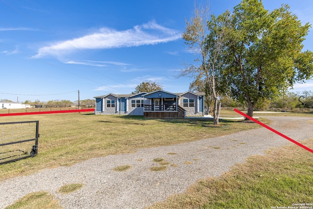 view of front of home with covered porch and a front yard