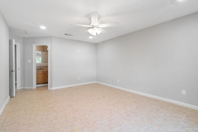 empty room featuring ceiling fan and sink