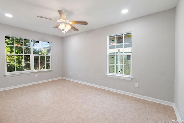 tiled spare room with ceiling fan