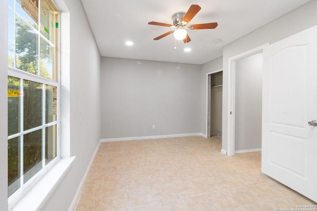 unfurnished bedroom featuring ceiling fan and multiple windows