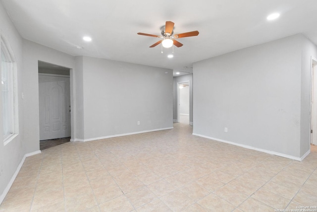 interior space with ceiling fan and light tile patterned floors