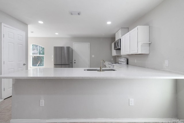 kitchen with kitchen peninsula, stainless steel appliances, sink, white cabinetry, and light tile patterned flooring