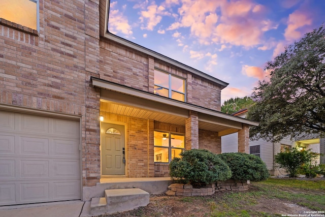 view of front facade featuring covered porch and a garage