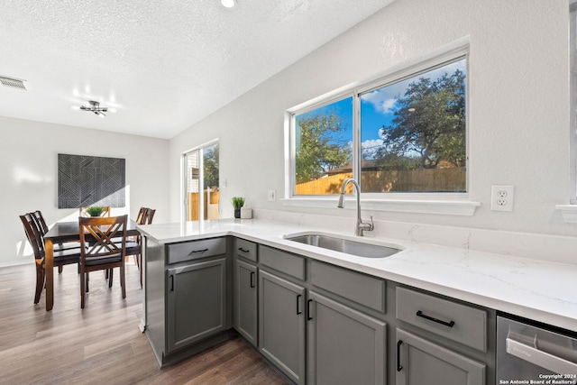 kitchen with gray cabinetry, sink, dark wood-type flooring, and a textured ceiling