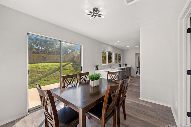 dining area with dark hardwood / wood-style flooring and sink