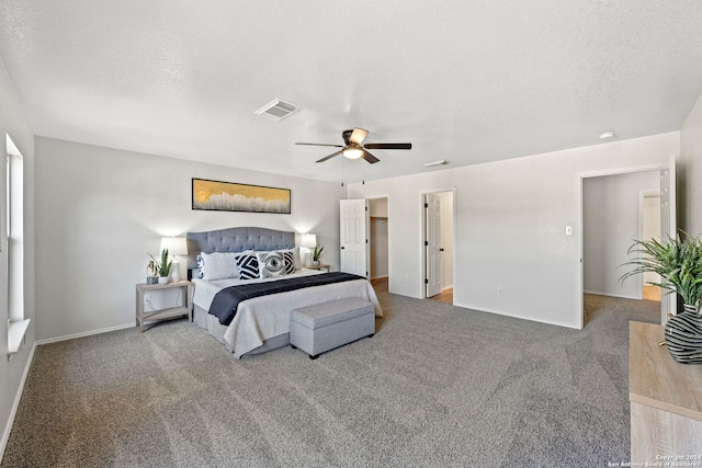 bedroom with carpet flooring, ceiling fan, and a textured ceiling