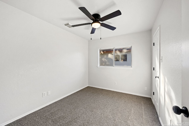 spare room with ceiling fan and carpet