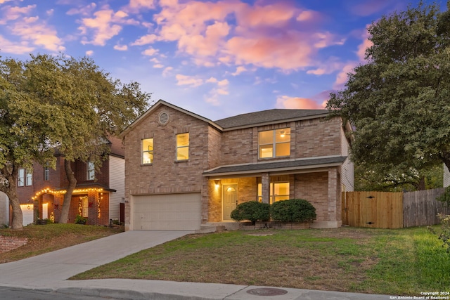 front facade with a garage and a lawn