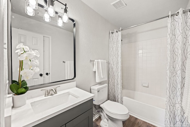 full bathroom with toilet, vanity, hardwood / wood-style flooring, and shower / tub combo with curtain