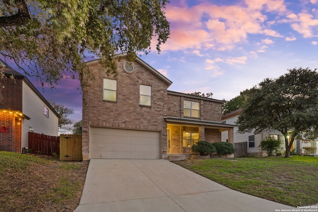 front of property featuring a lawn and a garage