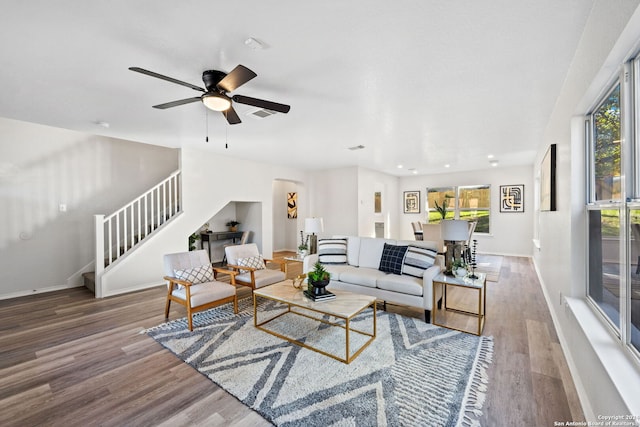 living room with ceiling fan and wood-type flooring