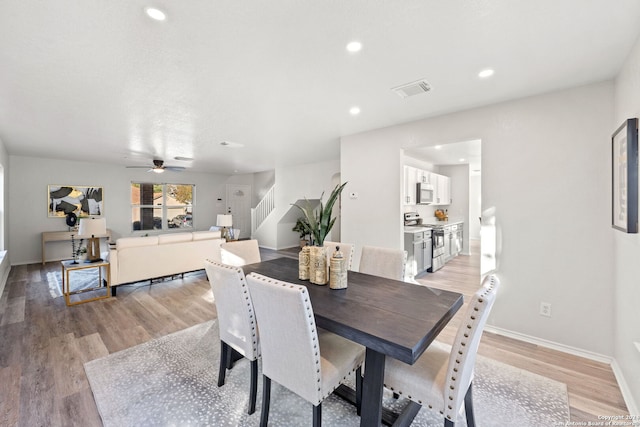 dining room featuring light wood-type flooring and ceiling fan