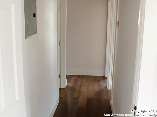 hall with dark hardwood / wood-style flooring and electric panel