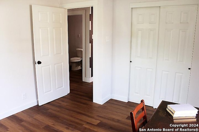 unfurnished bedroom featuring dark hardwood / wood-style flooring and a closet