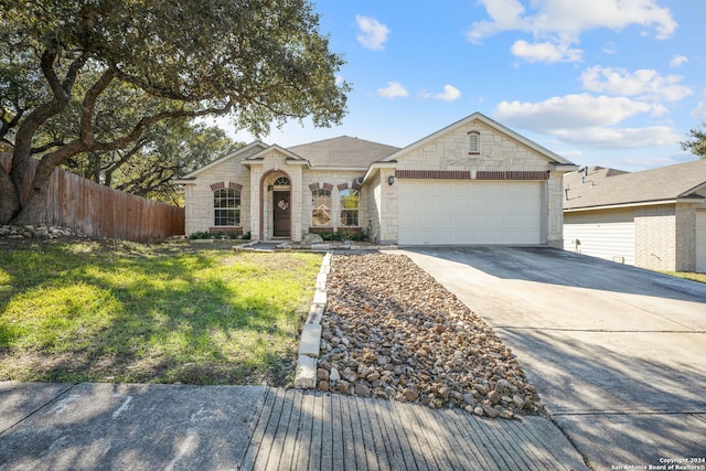 ranch-style home with a front yard and a garage