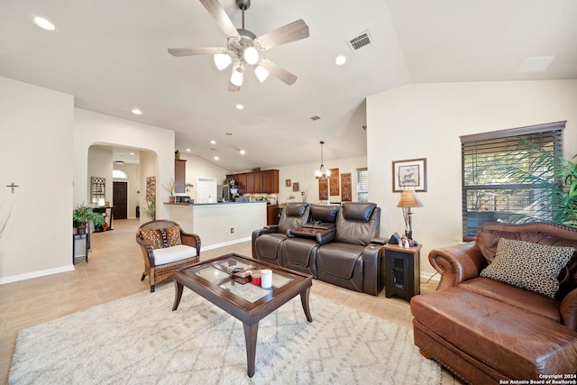 living room with ceiling fan with notable chandelier, light tile patterned flooring, and vaulted ceiling