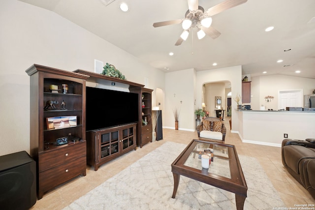 living room featuring ceiling fan, lofted ceiling, and light tile patterned flooring