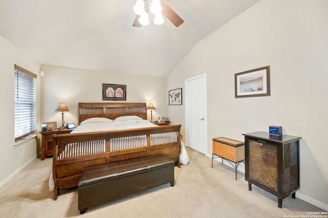 bedroom with ceiling fan, light colored carpet, and vaulted ceiling