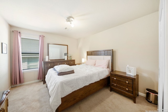 bedroom featuring light colored carpet