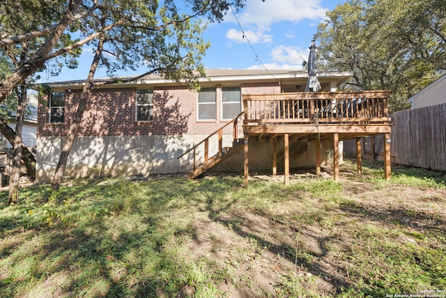 rear view of property featuring a deck