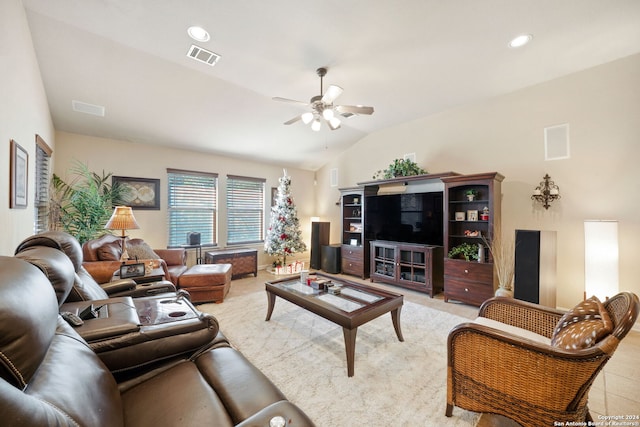 tiled living room featuring ceiling fan and vaulted ceiling