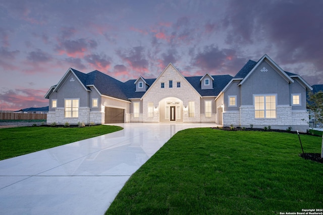 view of front of property featuring a yard and a garage