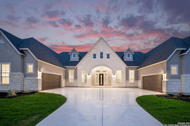 view of front facade with a garage and a lawn