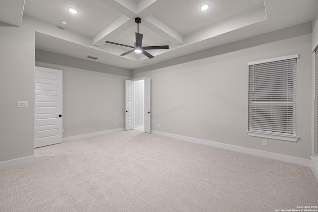 spare room with beam ceiling, light carpet, ceiling fan, and coffered ceiling