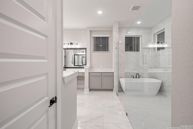 bathroom featuring separate shower and tub and vanity