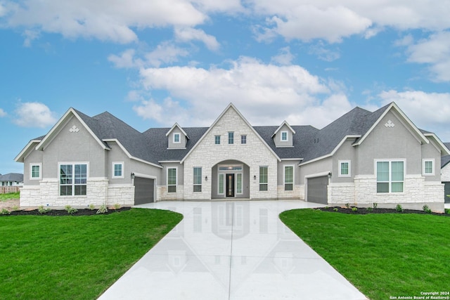 view of front of home with a garage and a front lawn