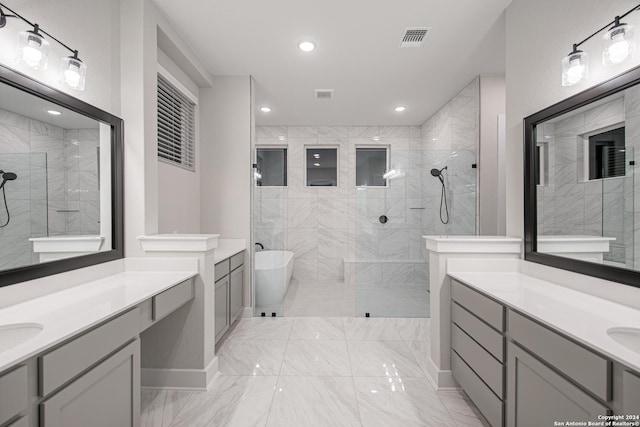 bathroom featuring vanity and separate shower and tub