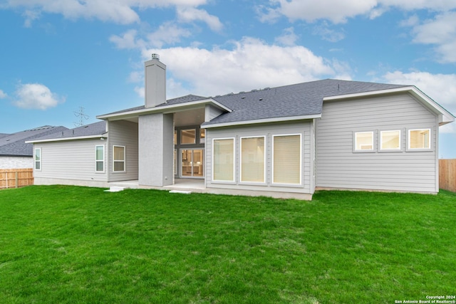 rear view of house with a yard