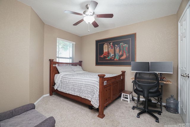 bedroom featuring light colored carpet and ceiling fan