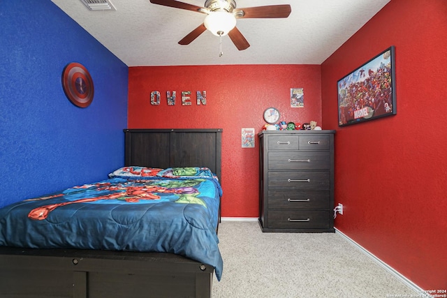 carpeted bedroom with a textured ceiling and ceiling fan