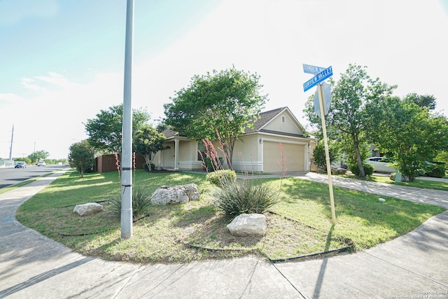 view of front of property with a garage and a front lawn