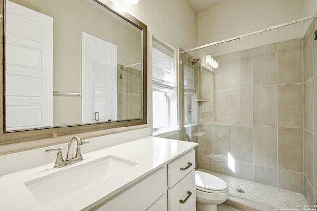 bathroom featuring vanity, toilet, and walk in shower