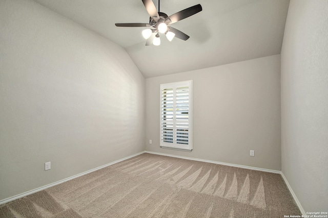 carpeted empty room featuring ceiling fan and lofted ceiling