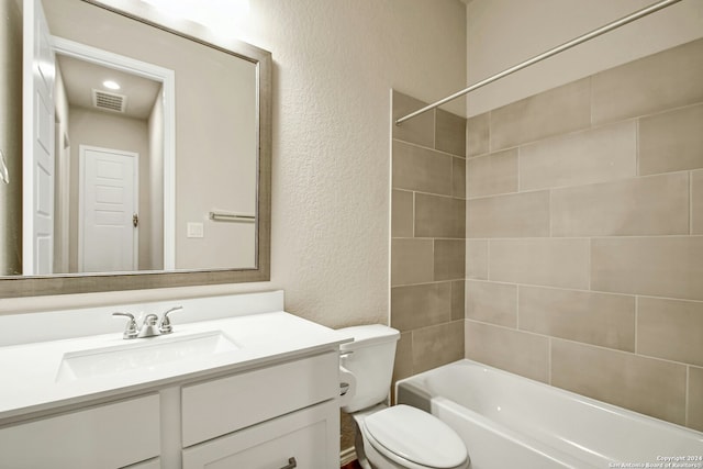 full bathroom with vanity, toilet, and tiled shower / bath